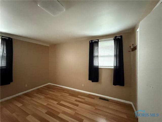 empty room with light hardwood / wood-style floors