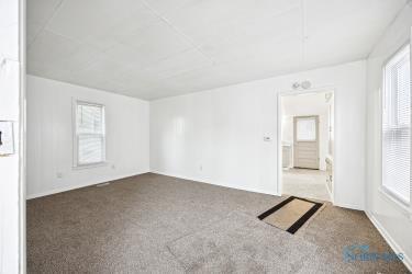 spare room featuring dark carpet