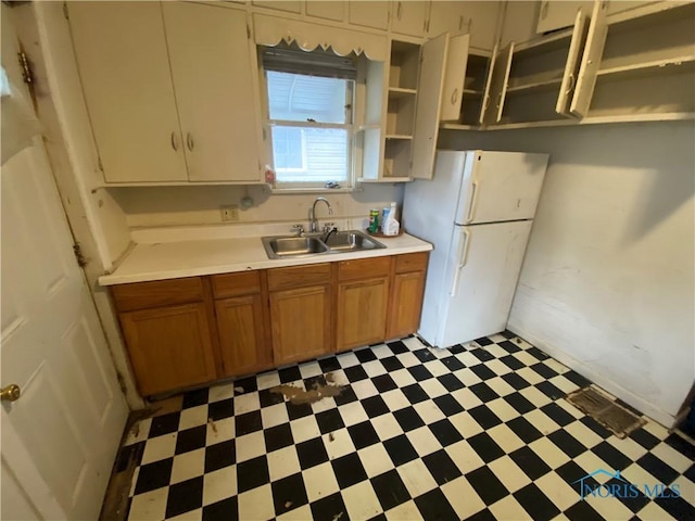 kitchen featuring white refrigerator and sink