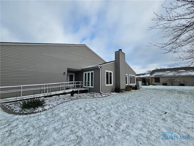 snow covered property featuring a wooden deck