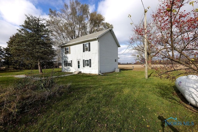 view of side of property with a lawn