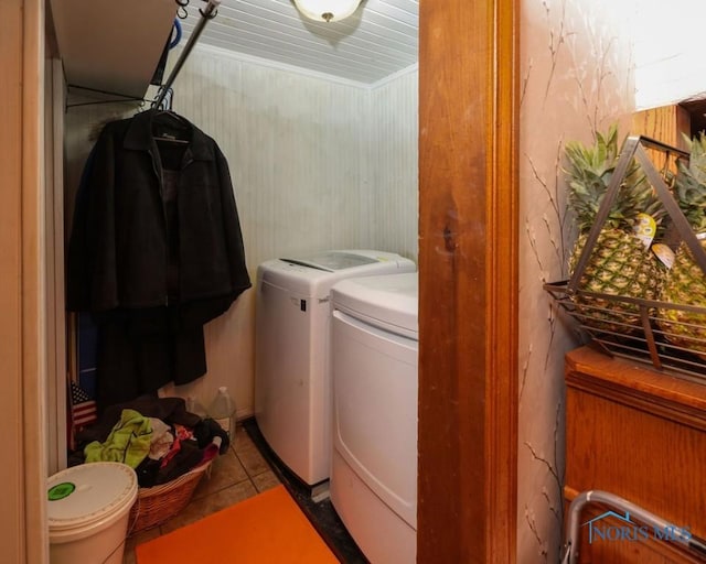 clothes washing area featuring light tile patterned floors and washing machine and clothes dryer