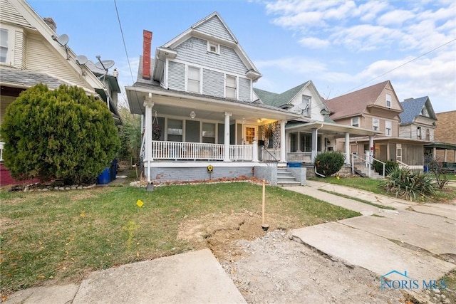 534 Acklin Ave, Toledo, OH 43620 - view of front of home featuring covered porch, a front lawn, and a chimney