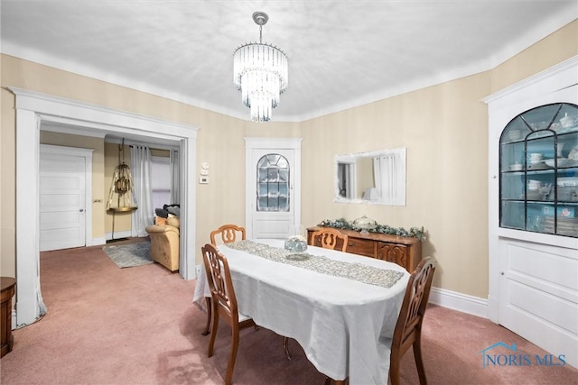 534 Acklin Ave, Toledo, OH 43620 - carpeted dining area featuring a chandelier and baseboards