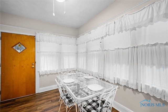 dining room with dark hardwood / wood-style flooring