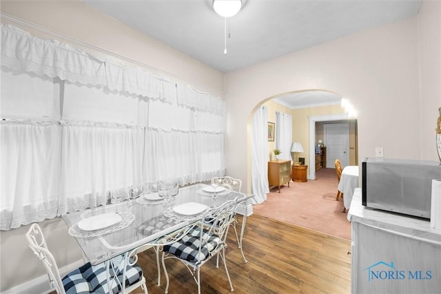 534 Acklin Ave, Toledo, OH 43620 - dining room featuring arched walkways, wood finished floors, and crown molding