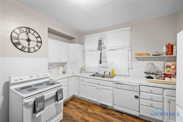 kitchen with white appliances, dark wood-type flooring, white cabinets, sink, and tasteful backsplash