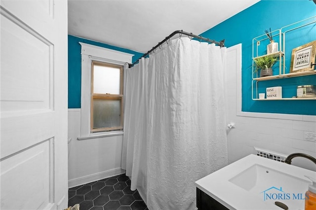 bathroom featuring a shower with curtain, tile patterned flooring, and vanity