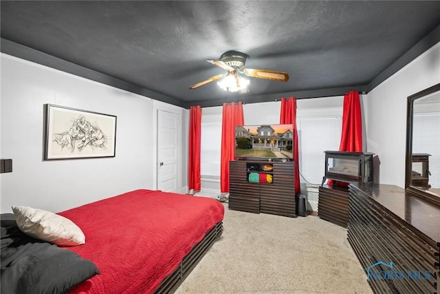 534 Acklin Ave, Toledo, OH 43620 - carpeted bedroom with a wood stove and a ceiling fan