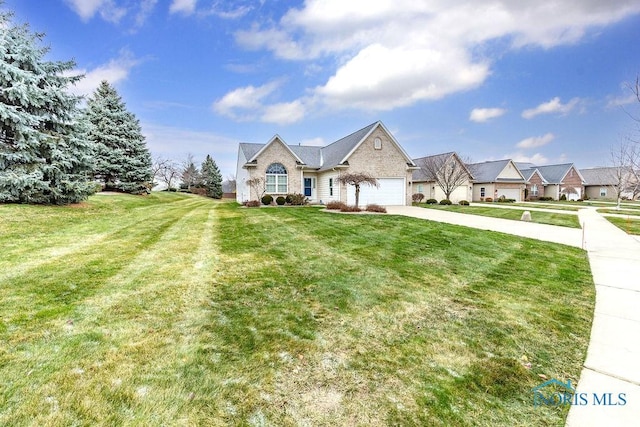 view of front of home featuring a garage and a front lawn