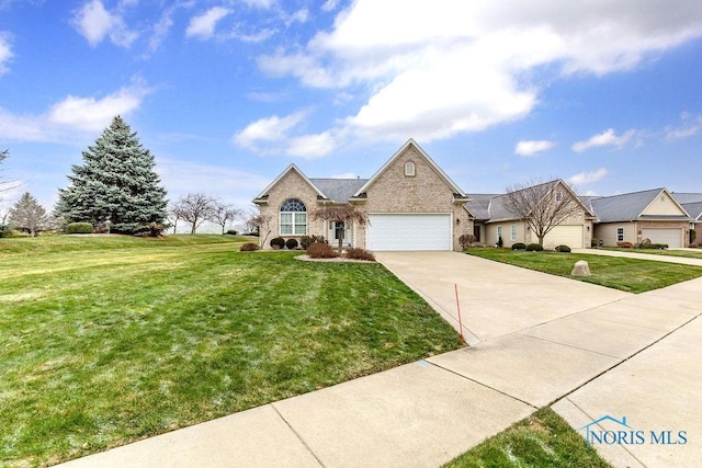 view of front of home with a garage and a front lawn