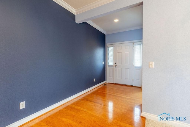 entrance foyer featuring wood-type flooring and ornamental molding