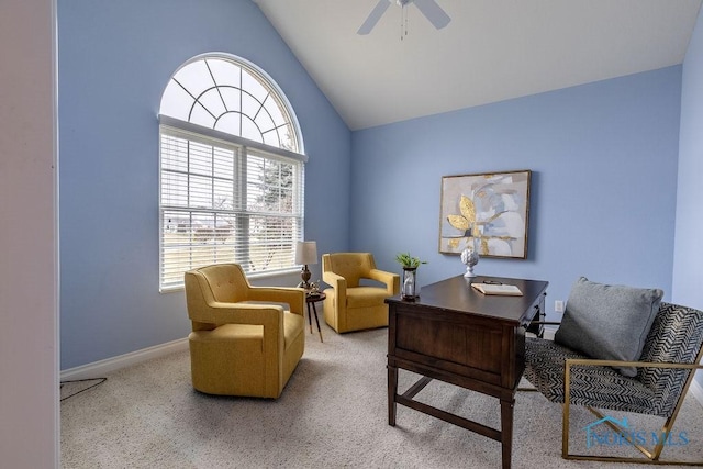 carpeted office space with ceiling fan and vaulted ceiling