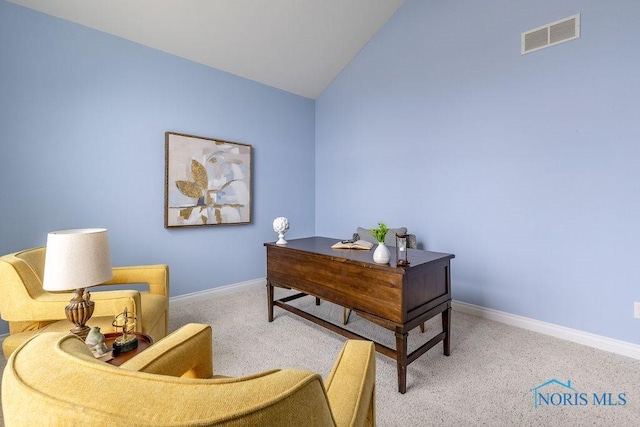 carpeted office featuring lofted ceiling