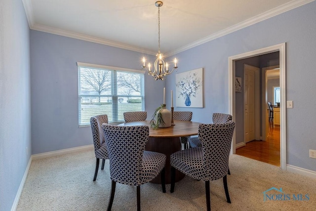 carpeted dining room with ornamental molding and a notable chandelier