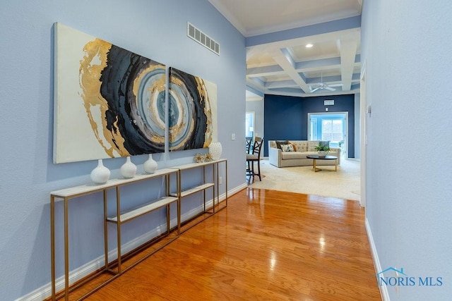 hall featuring coffered ceiling, beam ceiling, and wood-type flooring