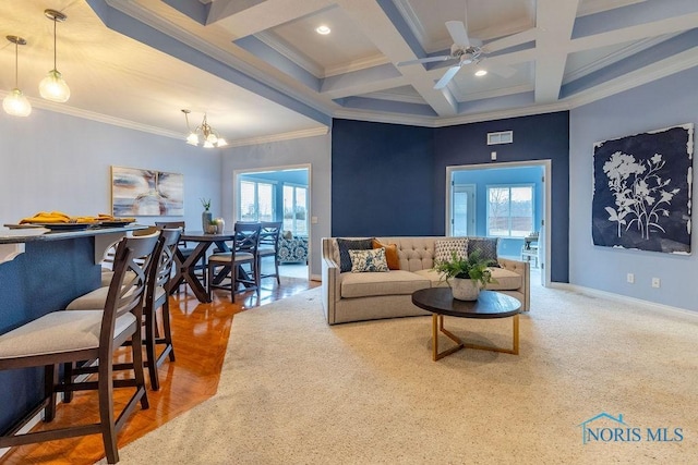 living room with coffered ceiling, ceiling fan with notable chandelier, crown molding, and beamed ceiling