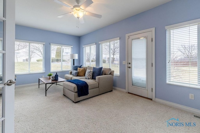 carpeted living room featuring ceiling fan