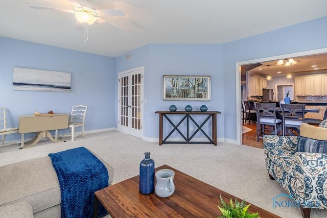 living room featuring light carpet and ceiling fan