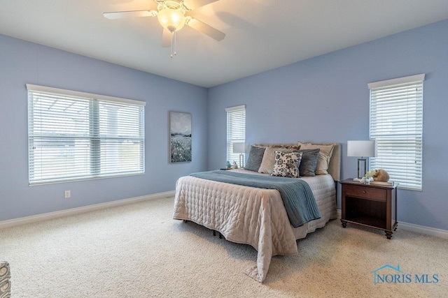 bedroom with ceiling fan, carpet, and multiple windows