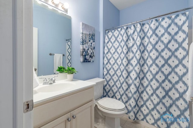 bathroom with vanity, tile patterned floors, toilet, and a shower with shower curtain