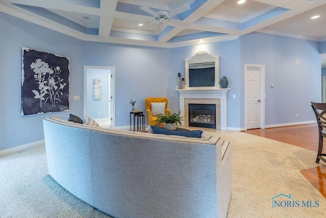 living room with coffered ceiling, ornamental molding, beamed ceiling, ceiling fan, and a high ceiling