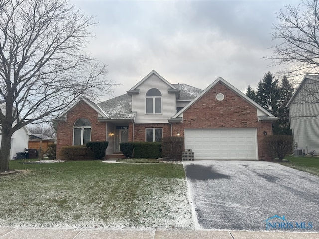 view of front property featuring central AC unit, a front yard, and a garage