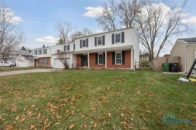 view of property with a porch, a garage, and a front lawn