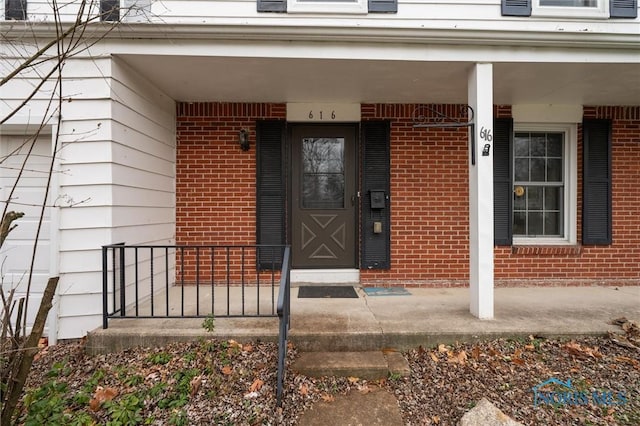 view of exterior entry with covered porch