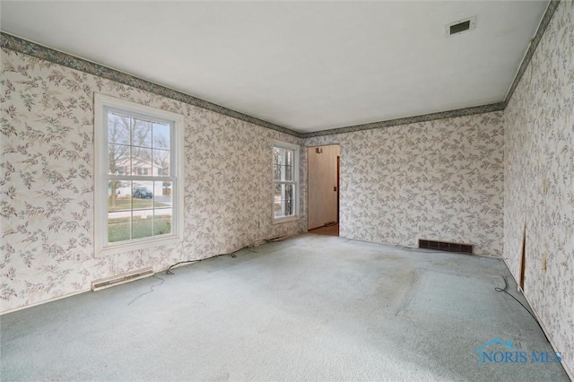 unfurnished room with carpet and crown molding