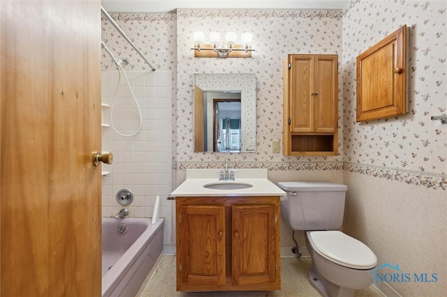 full bathroom with vanity, tiled shower / bath combo, and toilet