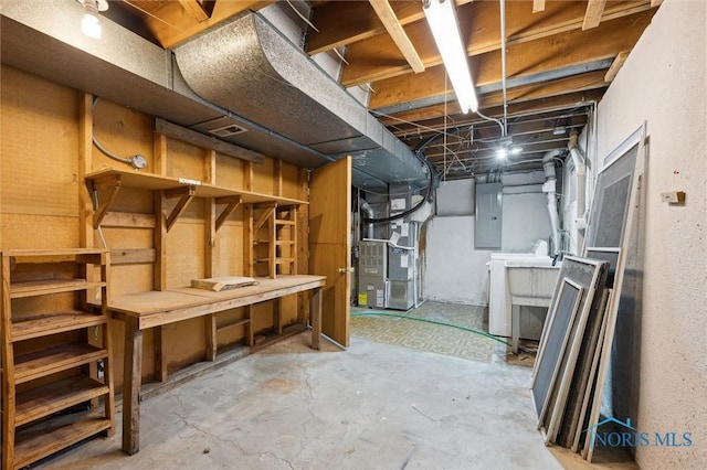 basement featuring electric panel and heating unit