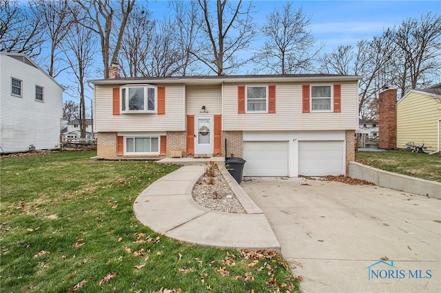 bi-level home with a front yard and a garage