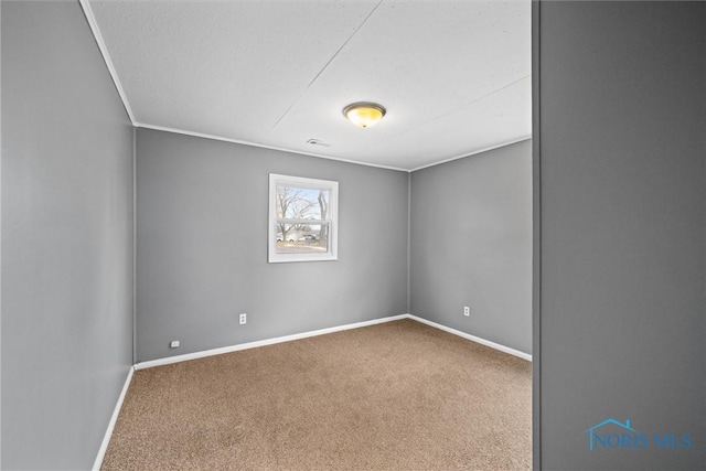 carpeted spare room with crown molding