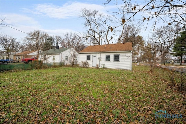 rear view of house with a yard