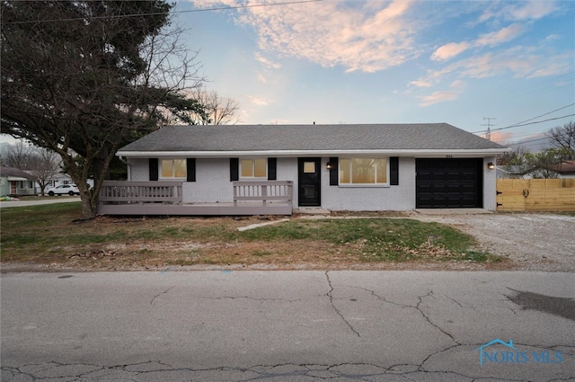 ranch-style house with a front lawn and a garage