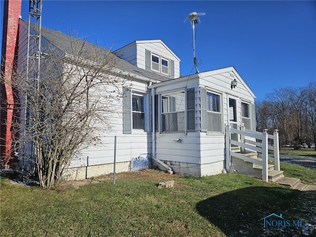 view of home's exterior with a yard