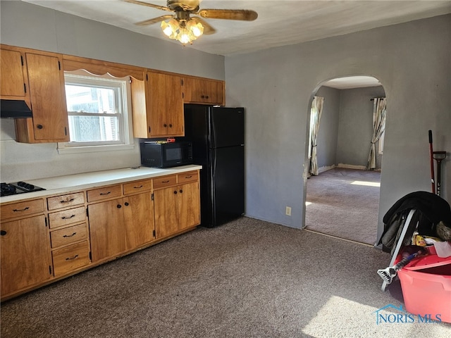 kitchen featuring dark carpet, ceiling fan, and black appliances