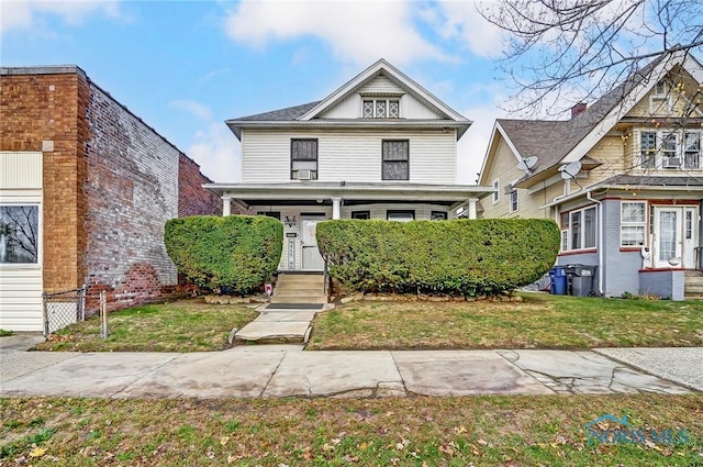 view of front of house featuring a porch and a front lawn