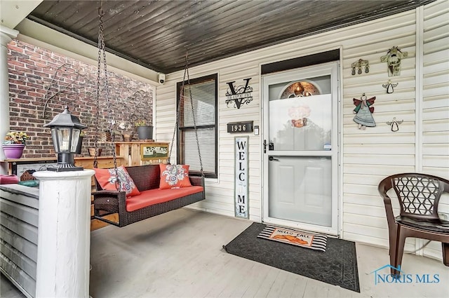 entrance to property featuring covered porch