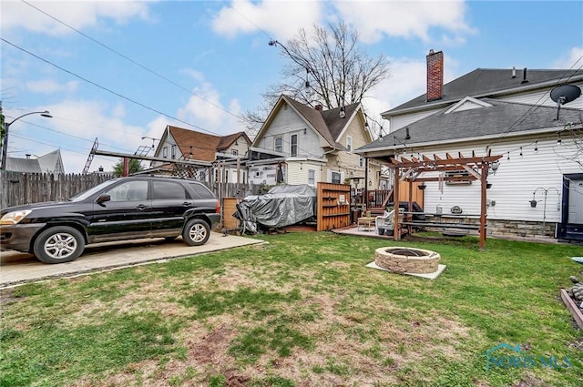 view of yard featuring a pergola and a fire pit