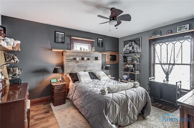 bedroom with hardwood / wood-style flooring and ceiling fan