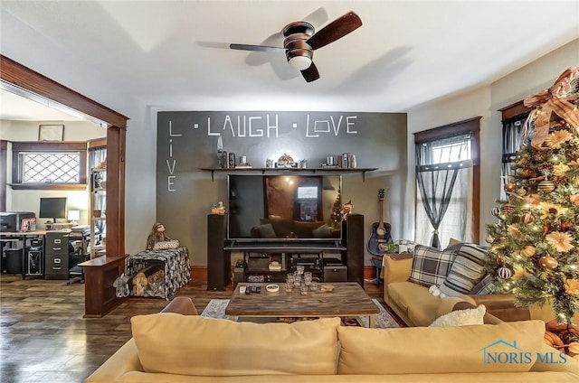 living room with dark hardwood / wood-style floors and ceiling fan