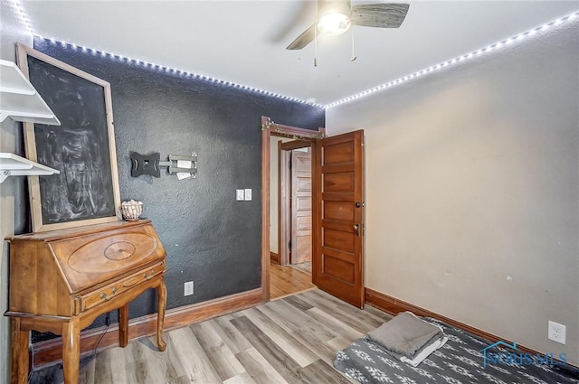 bedroom with ceiling fan and hardwood / wood-style flooring