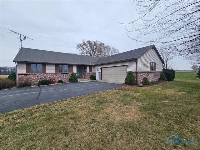 ranch-style home with a front yard and a garage