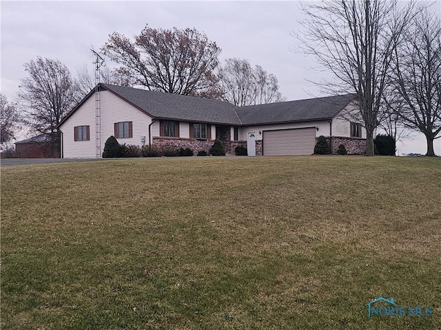 ranch-style home with a front yard and a garage