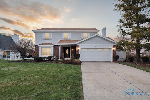 front of property featuring a garage and a lawn