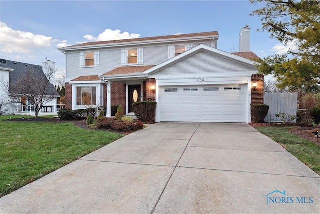 front of property with a garage and a front lawn