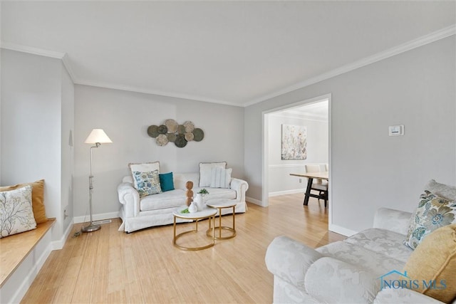 living room with hardwood / wood-style floors and ornamental molding