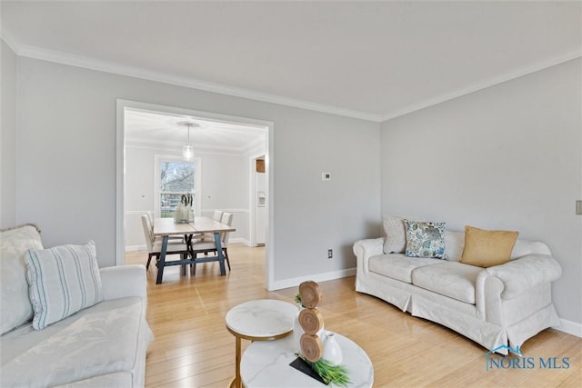 living room with hardwood / wood-style floors and crown molding